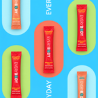 Four single-serve beverage replacement sticks from EVERYBODY are arranged on a bright blue background with pastel arch shapes. The center stick is red and labeled Strawberry Lemonade, while the surrounding sticks are orange and peach, labeled Apple Juice, Strawberry Lemonade, and Peach Refreshers.